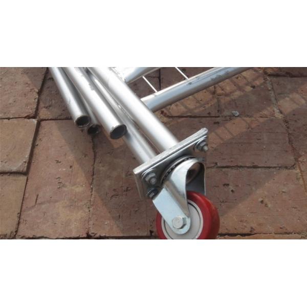 The corner of temporary fence panels, which lying on the ground. One of these panels is installed a red rubber wheel.