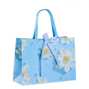 China Fresh White Chrysanthemum Pattern Sky Blue Cardboard Gift Bags With Ribbon Fashion Tote Bag on sale